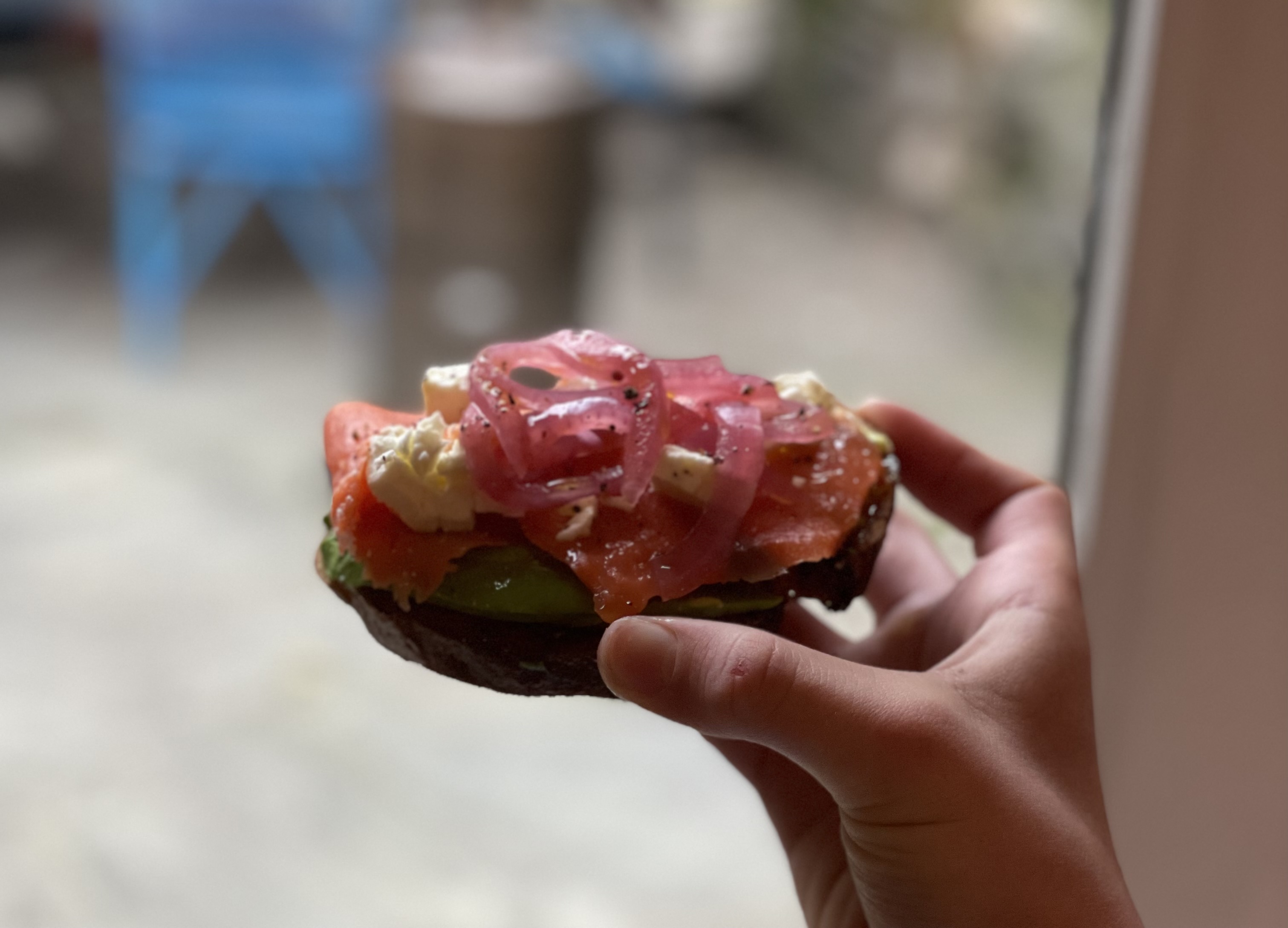 Toasted bread topped with red vegetables and white cheese