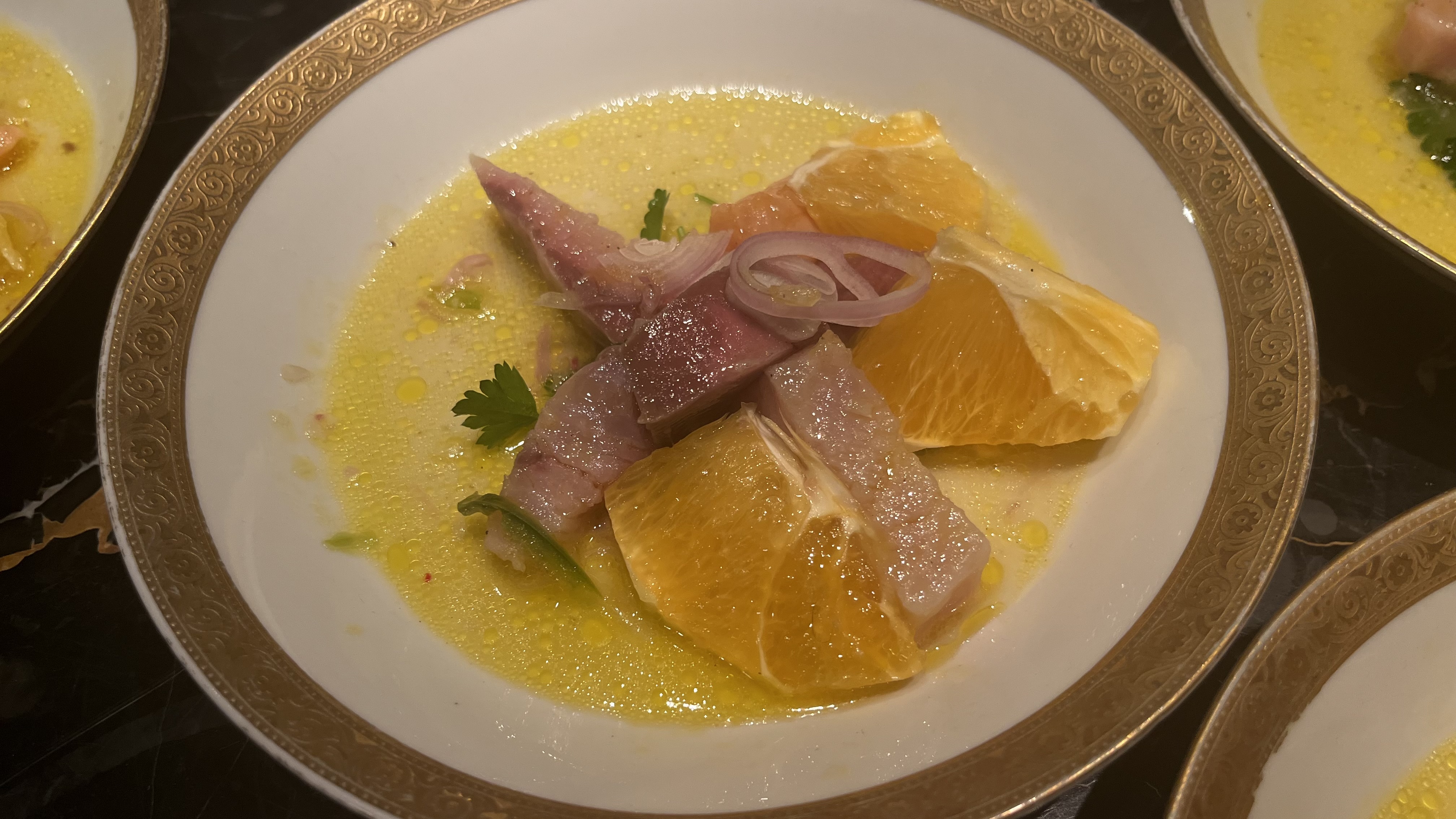 Fish crudo with orange, pickled shallots, and citrus leche de tigre