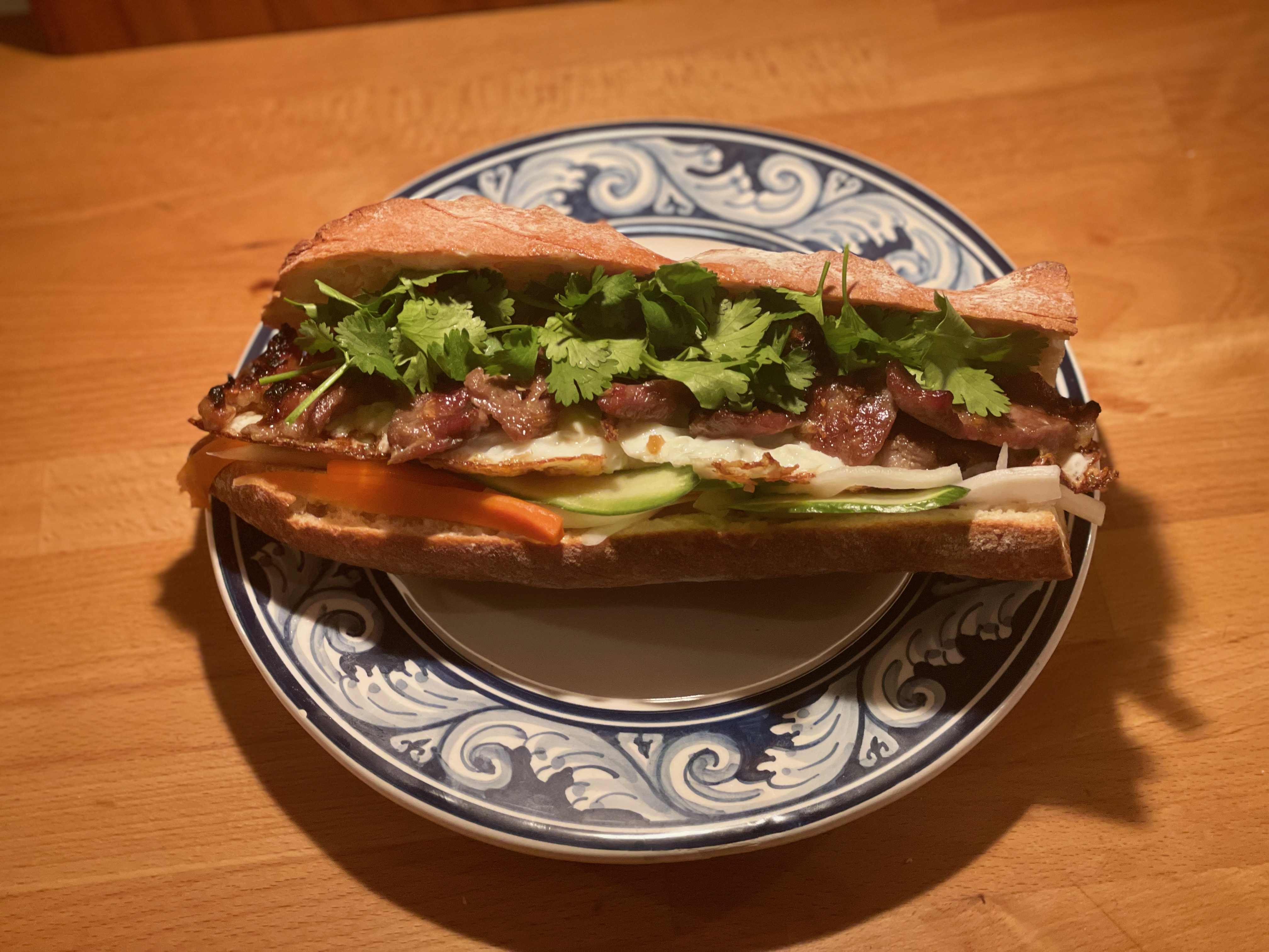 Bánh mì sandwich with grilled meat, cilantro, pickled vegetables, and cucumber