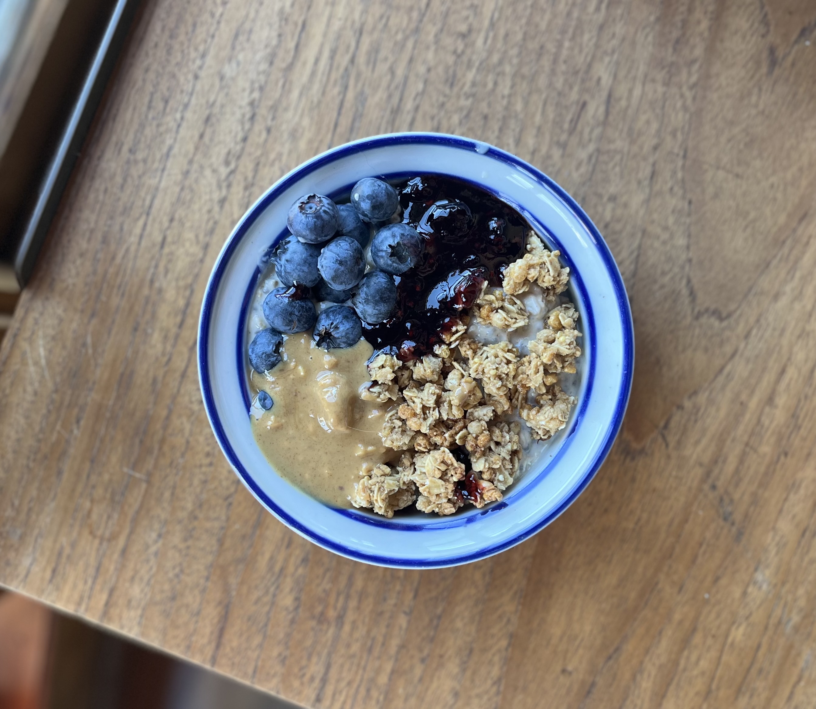 Bowl of yogurt or pudding with granola and fresh blueberries